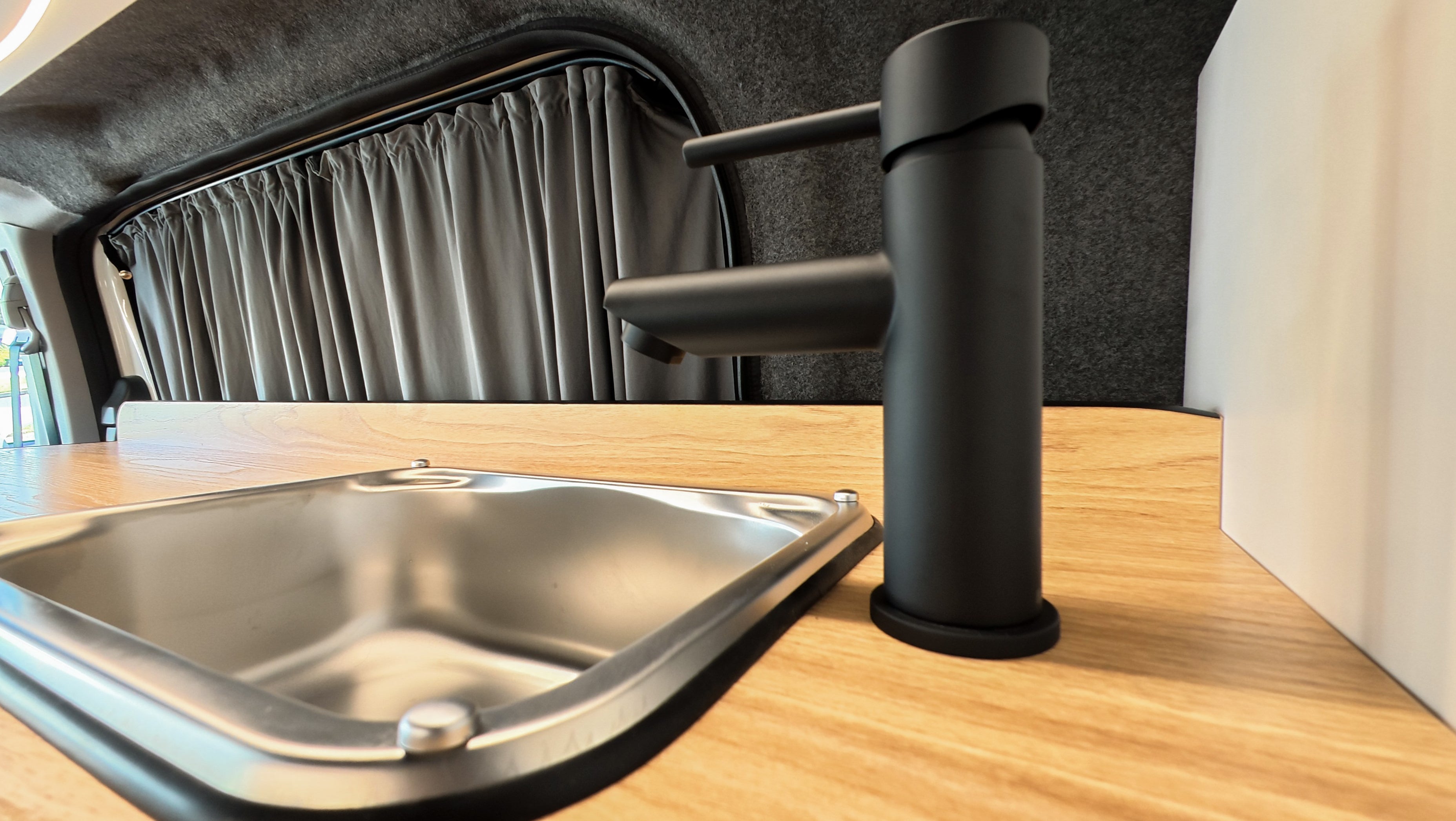 Taps and sink in the interior of Campervan